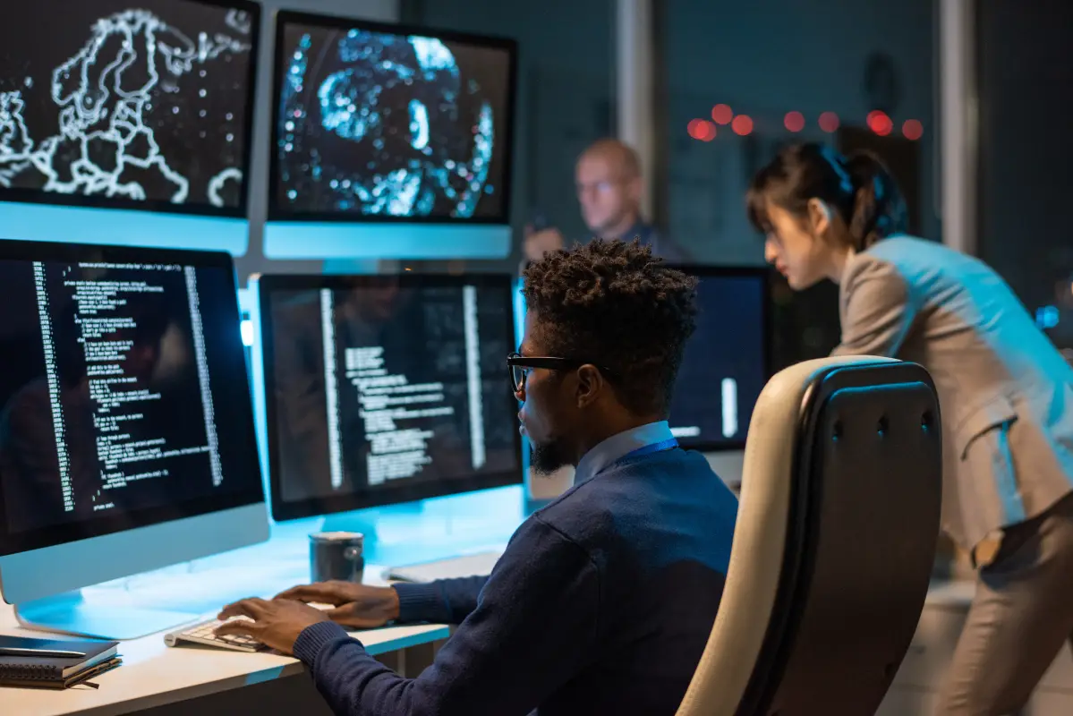People working with multiple computer screens